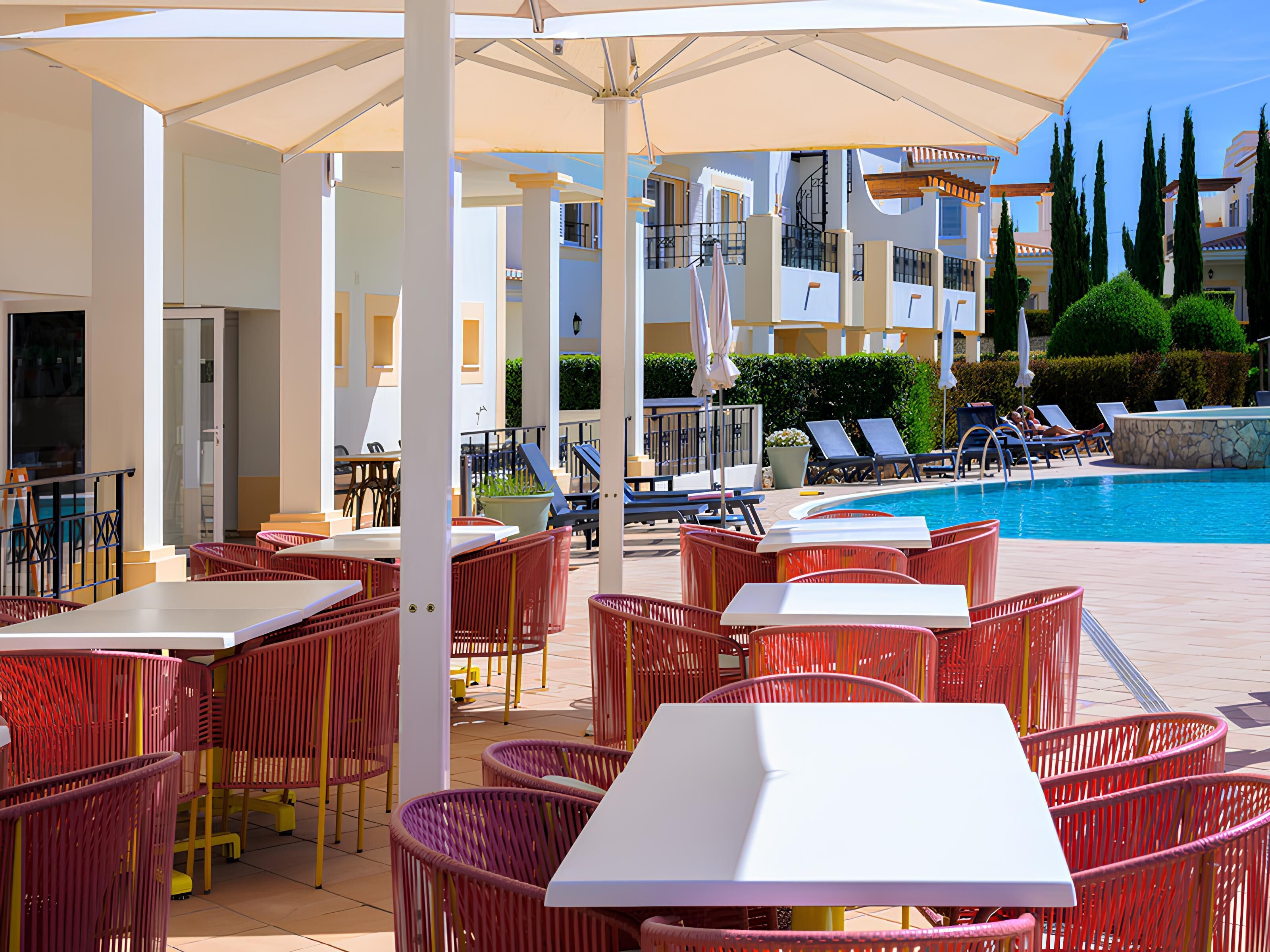 A poolside area with outdoor seating and a swimming pool.