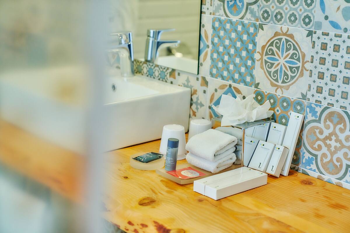 superior double room | bathroom | shower, free toiletries, hair dryer, towels