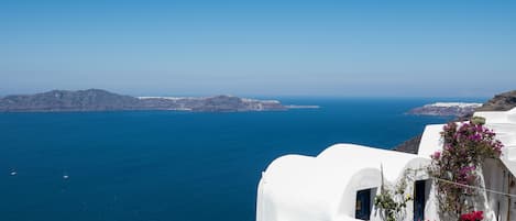 A pool area with a clear view of the sea and distant land.