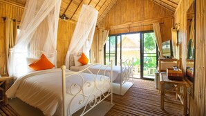 A room with a bed, a desk, and a window with a view of greenery. - Anyavee Krabi beach resort (Krabi)