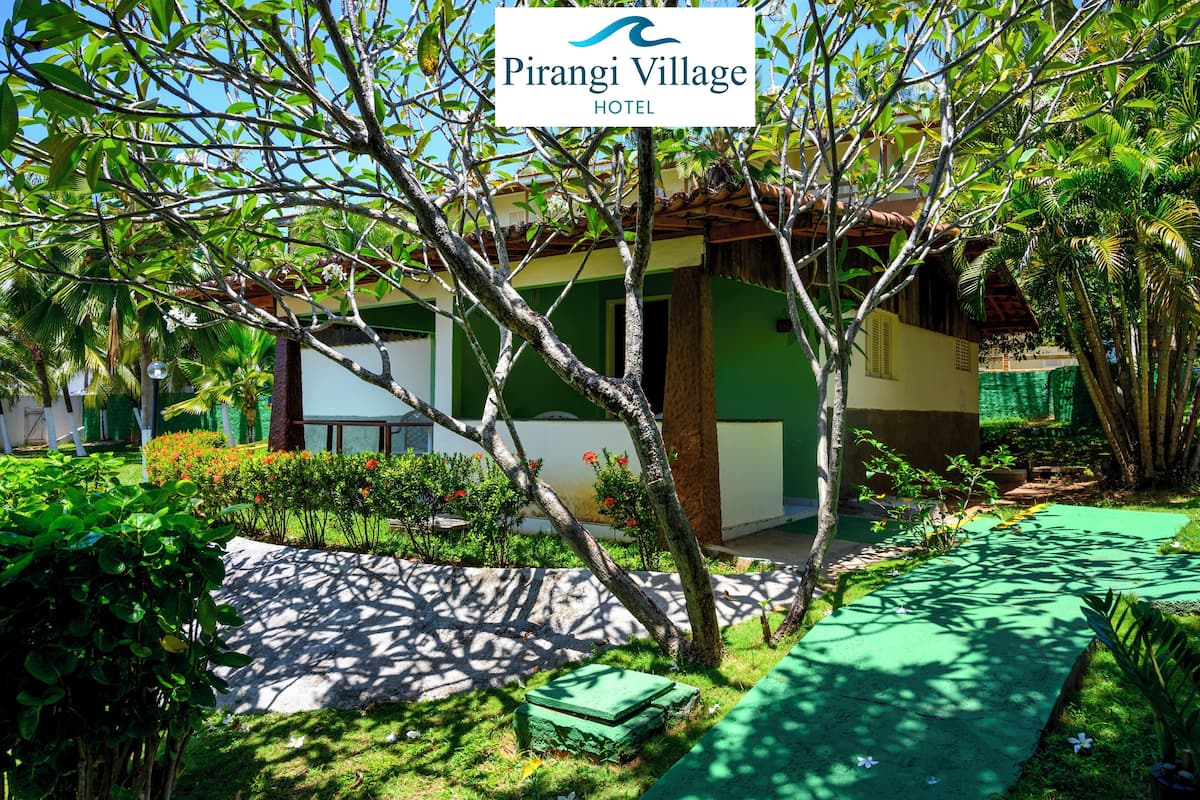 A lush garden with a building labeled "Pirangi Village Hotel".