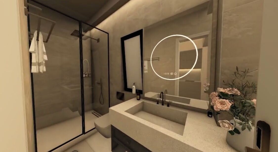 A modern bathroom with a glass shower enclosure, a large mirror, and a vase of flowers.