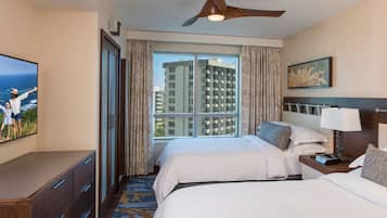A hotel room with two beds, a ceiling fan, a large window with curtains, a flat-screen TV, a wooden dresser, and a painting on the wall.