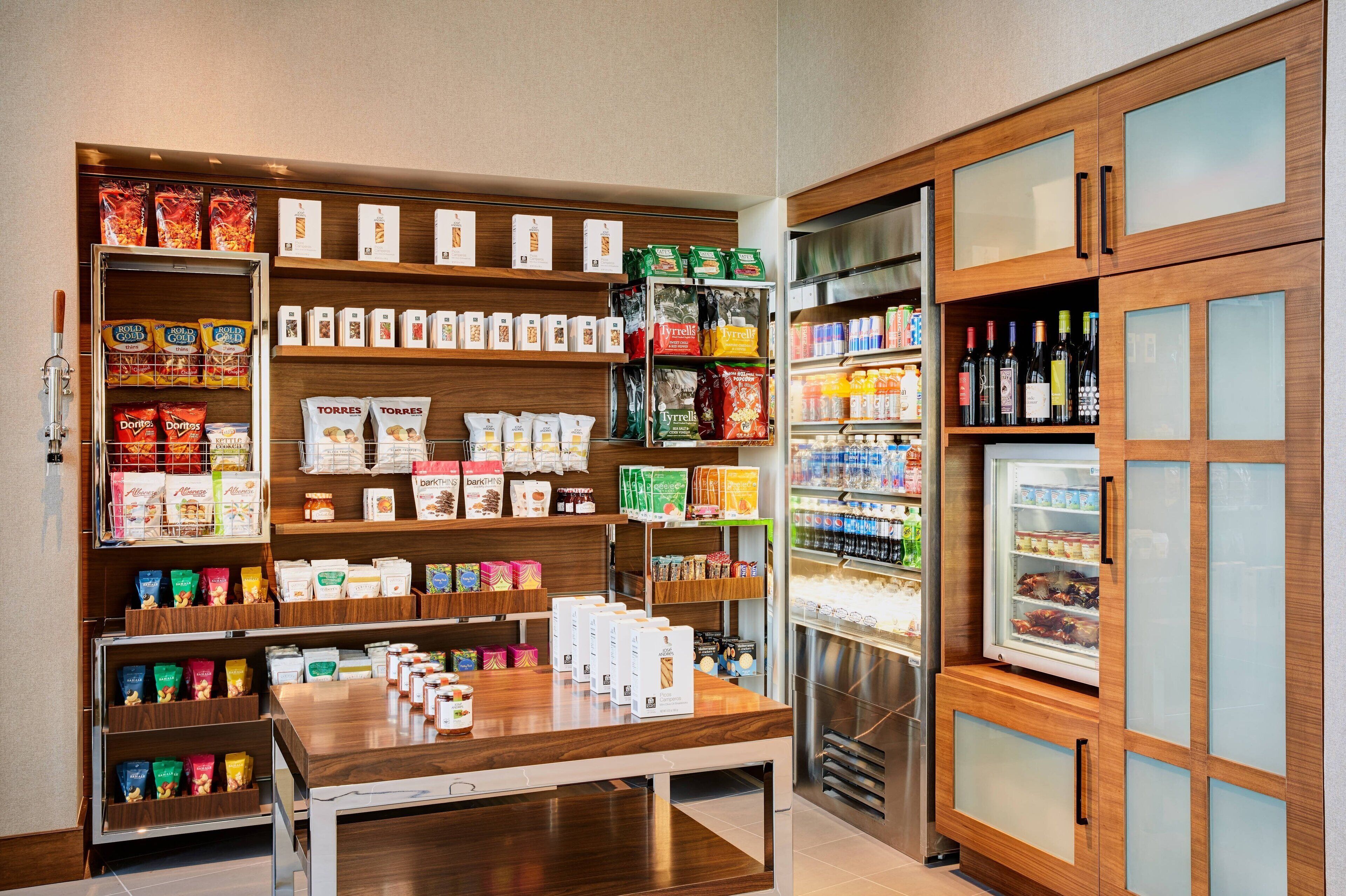 A grocery store with shelves stocked with snacks, beverages, and packaged goods.