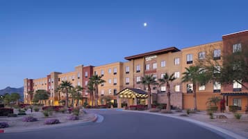 Experience the serene atmosphere of Homewood Suites, surrounded by beautifully landscaped gardens and a welcoming entrance.