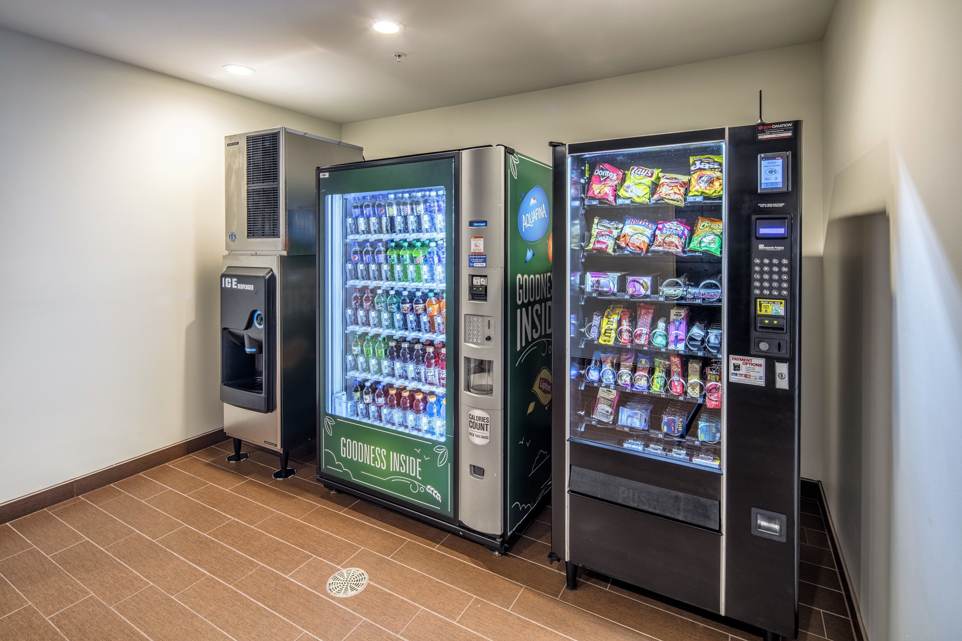 A row of vending machines with various beverages and snacks.