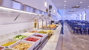 A buffet line with various food options and a seating area with tables and chairs. - Hotel Ilusion Vista Blava (Son Servera)