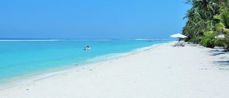 On the beach, beach umbrellas, beach towels, water skiing