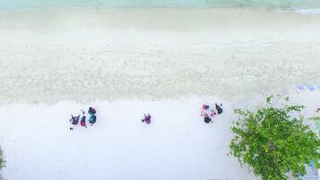On the beach, beach umbrellas, beach towels, waterskiing