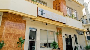 A hotel with a sign reading "AT-A-HEADS FESTIVAL HOTEL". - Ati-Atihan Festival Hotel (Kalibo)