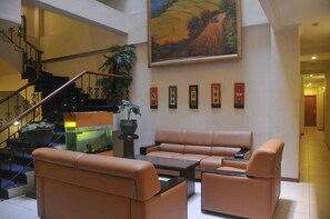 A spacious lobby with a staircase, leather seating, and a large landscape painting. - Losari Blok M  Hotel Jakarta (Jakarta)