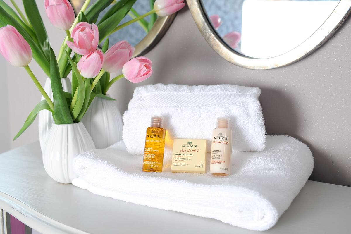 designer toiletries, hair dryer, towels, soap