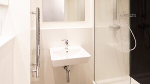 A modern bathroom with a glass shower enclosure, a white sink, and a toilet. - University of Bath Guest Accommodation (Bath)