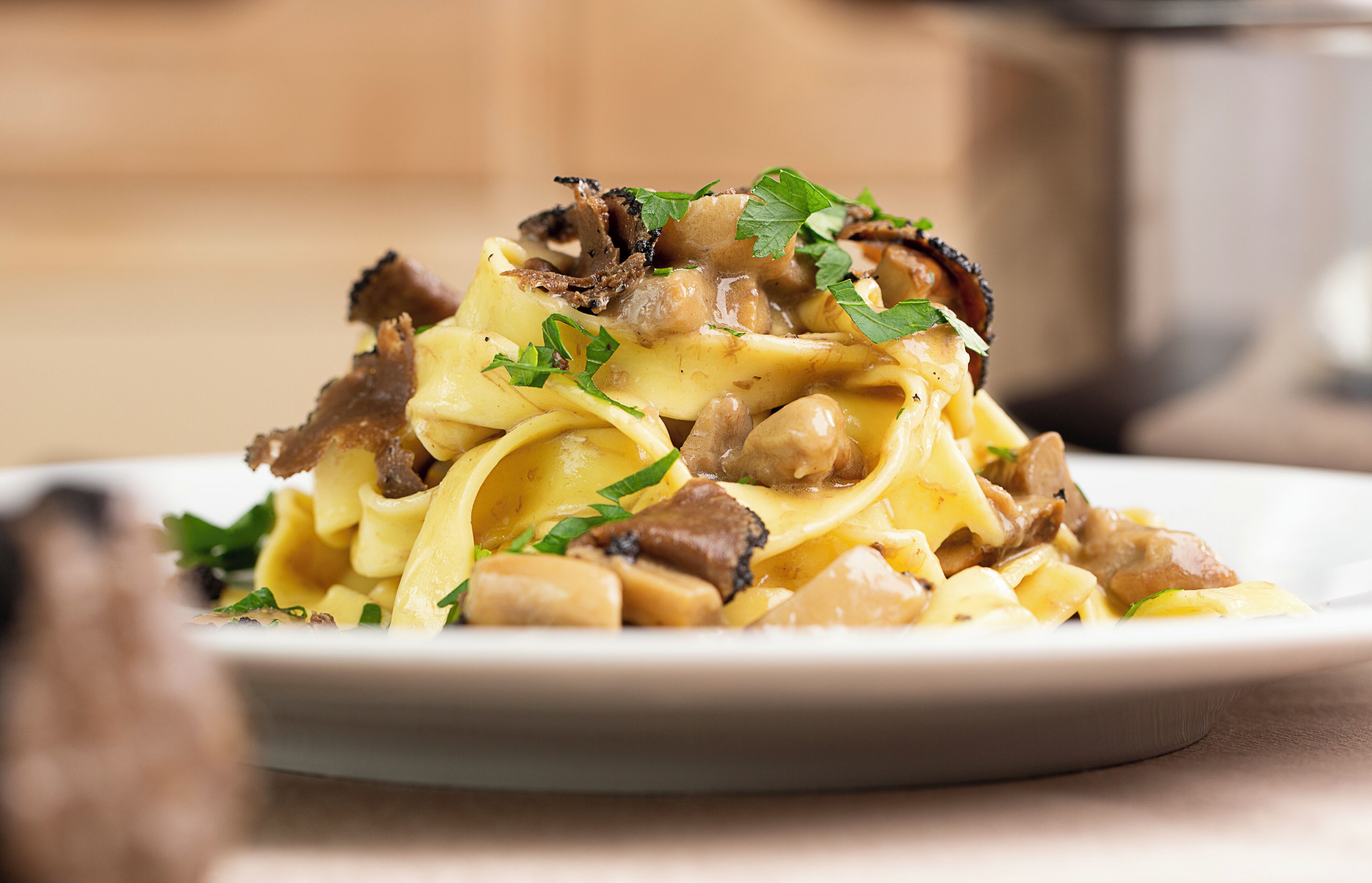 A plate of pasta with mushrooms and parsley.