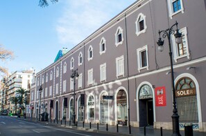 A historic building with multiple storefronts, including a hotel named 'SOLEX'.