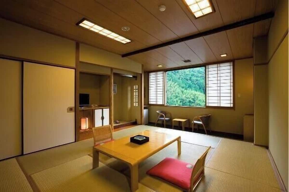 A traditional Japanese room with tatami flooring, a low wooden table, and sliding doors.