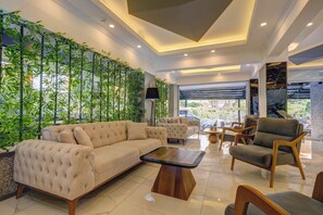 A modern lounge area with a sofa, armchairs, and a coffee table. - Miss Cleopatra Hotel (Alanya)