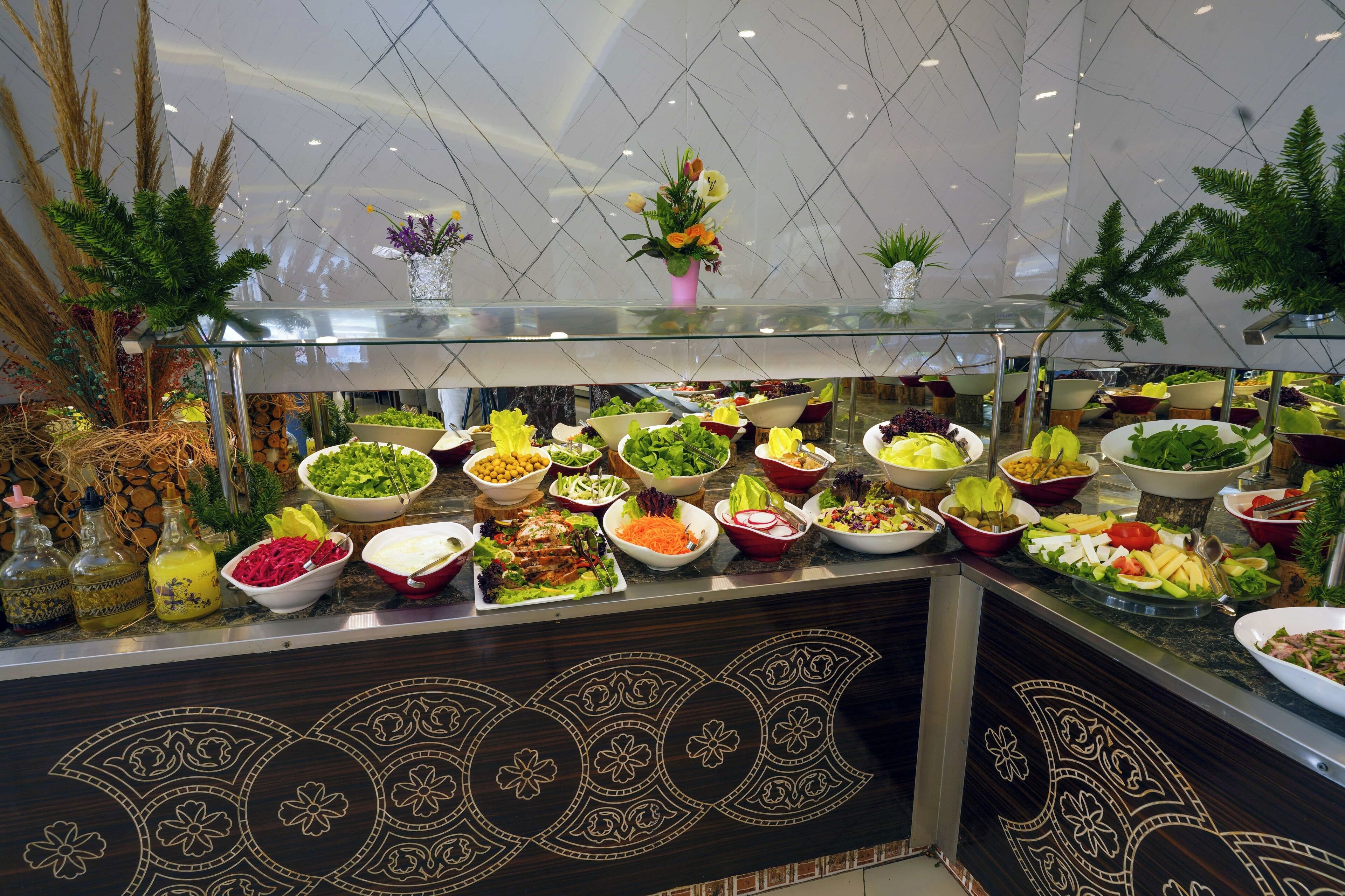 A buffet with various dishes and a decorative glass top.