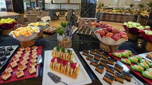 A buffet with various food items including fruits, pastries, and desserts. - Kleopatra Arsi Hotel (Alanya)