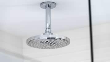 A modern showerhead with a chrome finish, mounted on a ceiling with a white background.