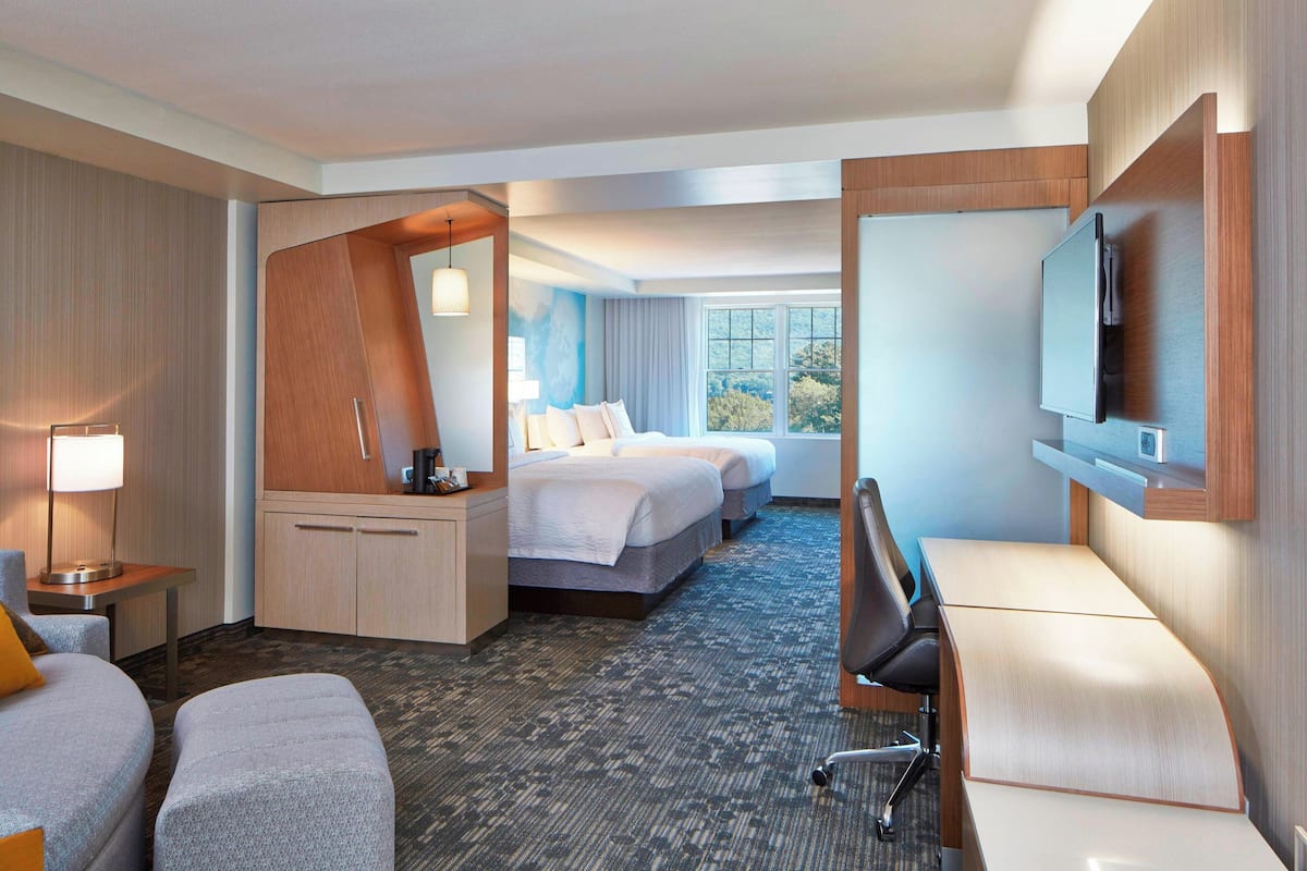 Premium bedding, desk, laptop workspace, blackout drapes