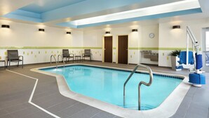 An indoor swimming pool with a tiled floor, a blue ceiling, and a few chairs around the pool area. - Fairfield Inn & Suites Lancaster East at The Outlets (Lancaster)