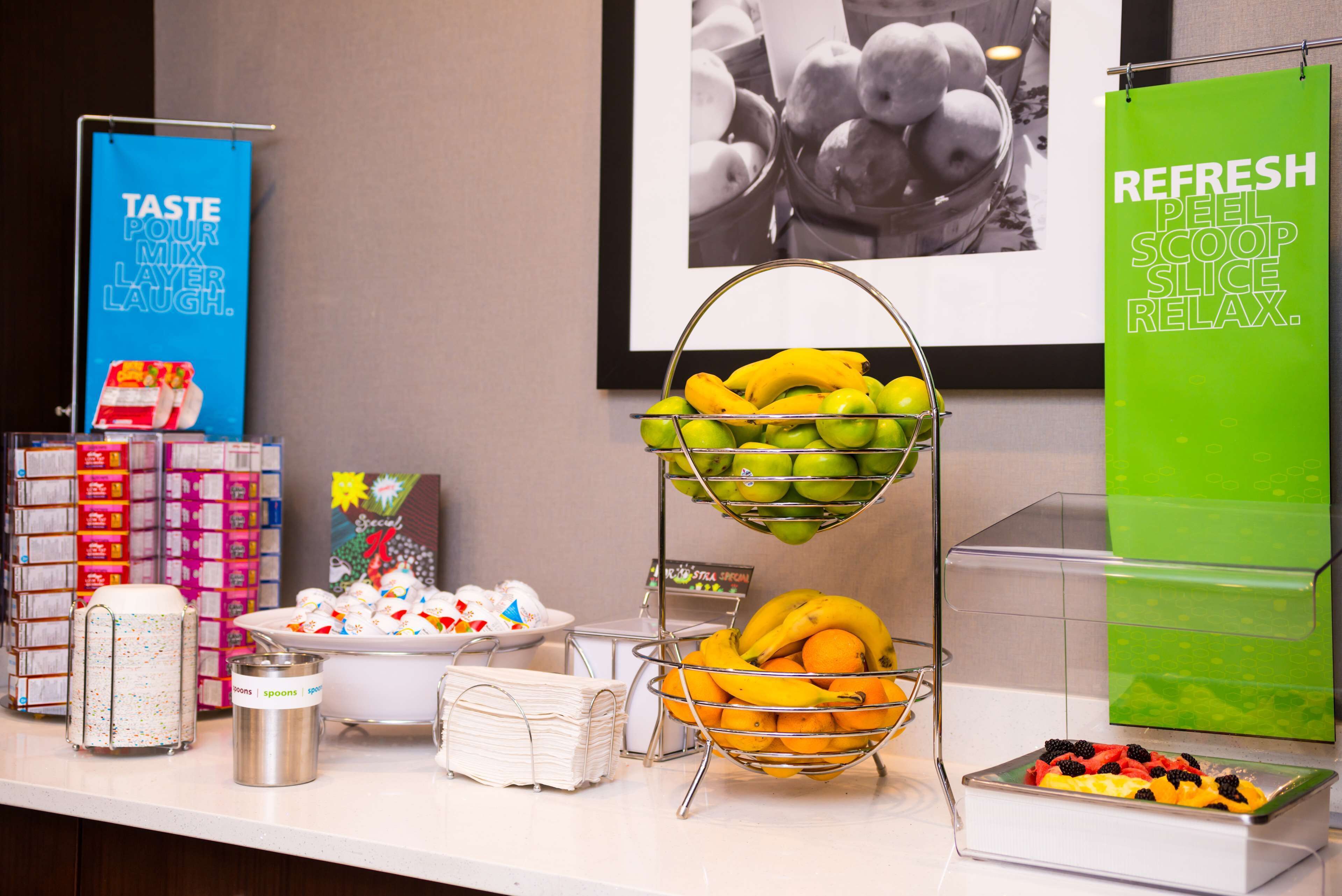 A buffet area with various fruits and condiments.
