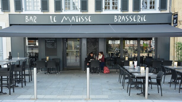 A cafe named Bar Le Matisse with outdoor seating and a chalkboard menu. - Le Matisse (Pau)