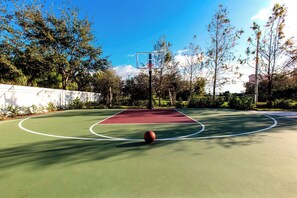 An outdoor basketball court with a hoop, surrounded by trees and a clear sky. - TownePlace Suites by Marriott Miami Homestead (Homestead)
