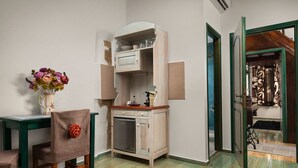 Une pièce comprenant une table à manger, une chaise, un buffet et une porte donnant sur une autre pièce.