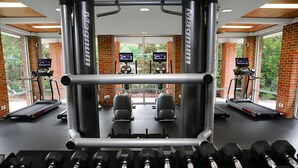 A gym with treadmills, weight machines, and dumbbells. - The Inn at Ole Miss (University)