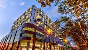 A modern hotel with multiple floors, large windows, and a prominent entrance. - Hilton Kota Kinabalu (Kota Kinabalu)