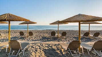 On the beach, sun-loungers, beach umbrellas