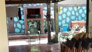 An open-plan area with a tiled floor, ceiling fans, and a view of the outside. - Nueva Alborada Lodging House (Fernando De La Mora)