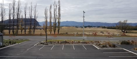 A parking lot with a view of mountains and a clear sky.