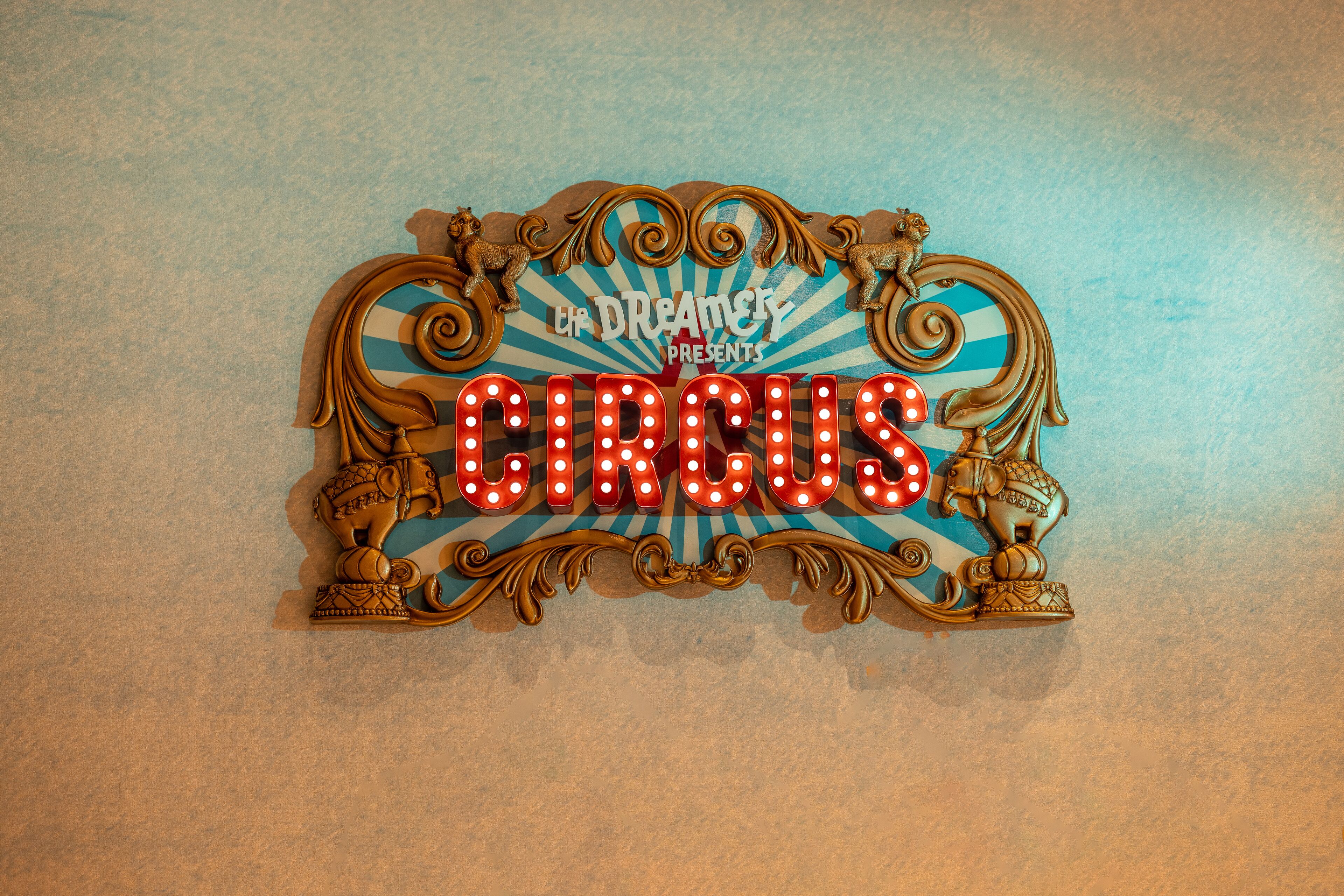 A decorative sign with the word "CIRCUS" and a logo that reads "UP DREAMER PRESENTS".