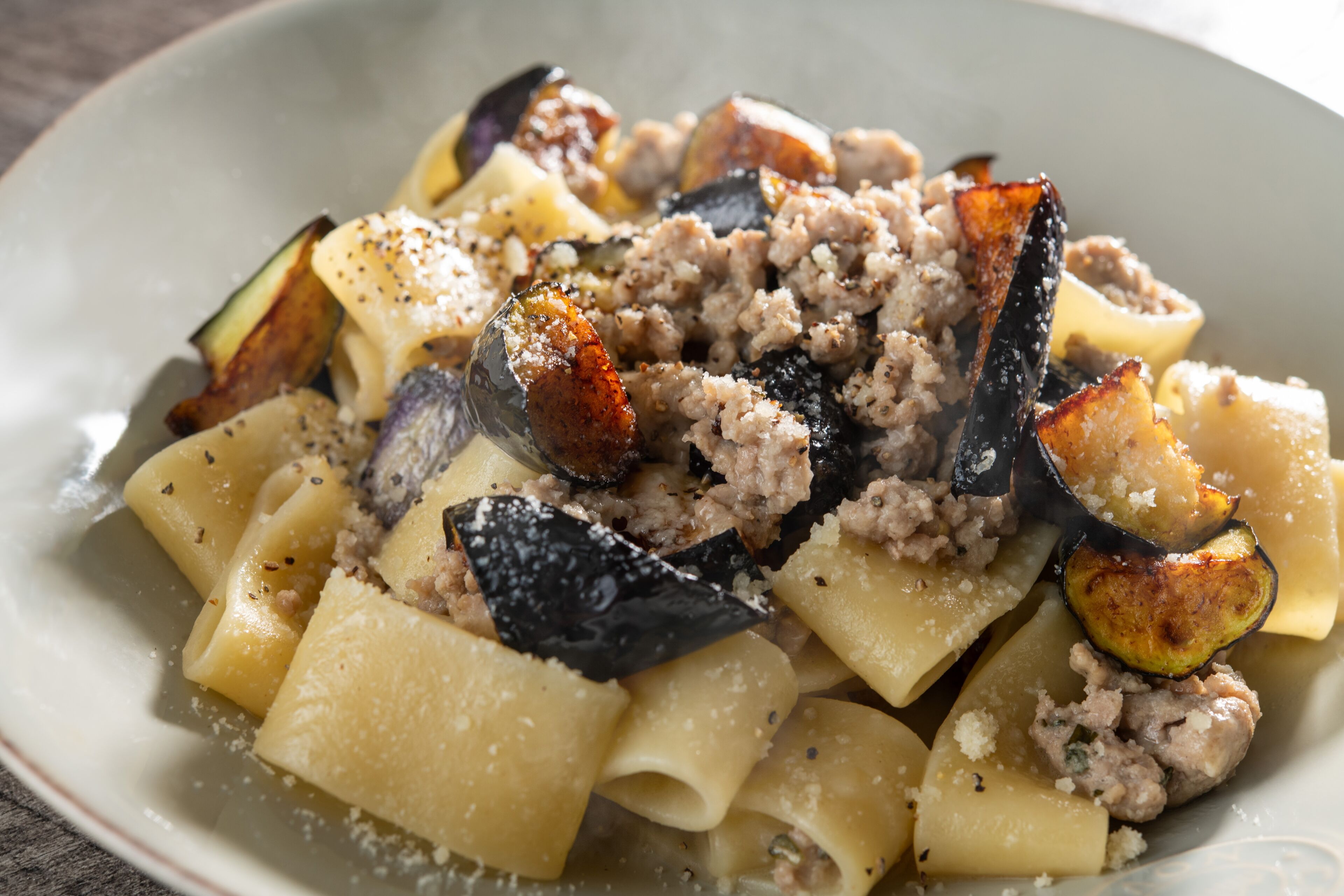 A plate of pasta with vegetables and ground meat.