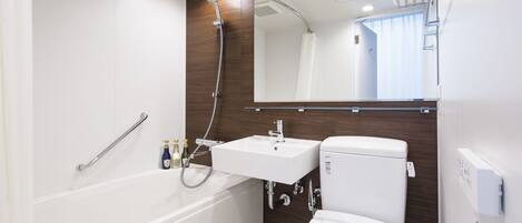 A modern bathroom with a bathtub, a sink, and a toilet.