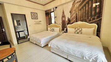 A hotel room with two beds, a chandelier, a bathroom with a mirror, and a wall mural of a cityscape.