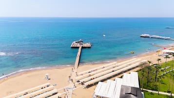 Plage privée, sable noir, chaises longues, parasols