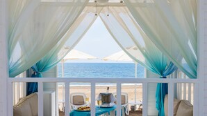 A beachside dining area with a table set for two, overlooking the sea. - Arcanus Hotels Sorgun - All Inclusive (Manavgat)