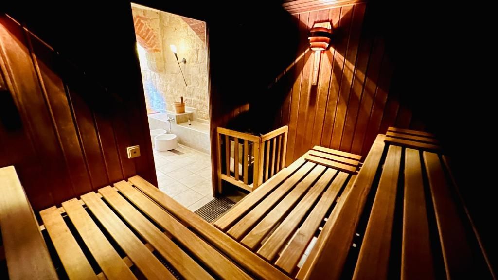 A wooden staircase leading to a bathroom with a white sink and a shower.