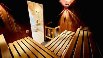 A wooden staircase leading to a bathroom with a white sink and a shower.