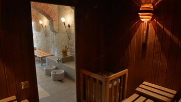 Relax in a cozy seating area with a bench and stone wall.