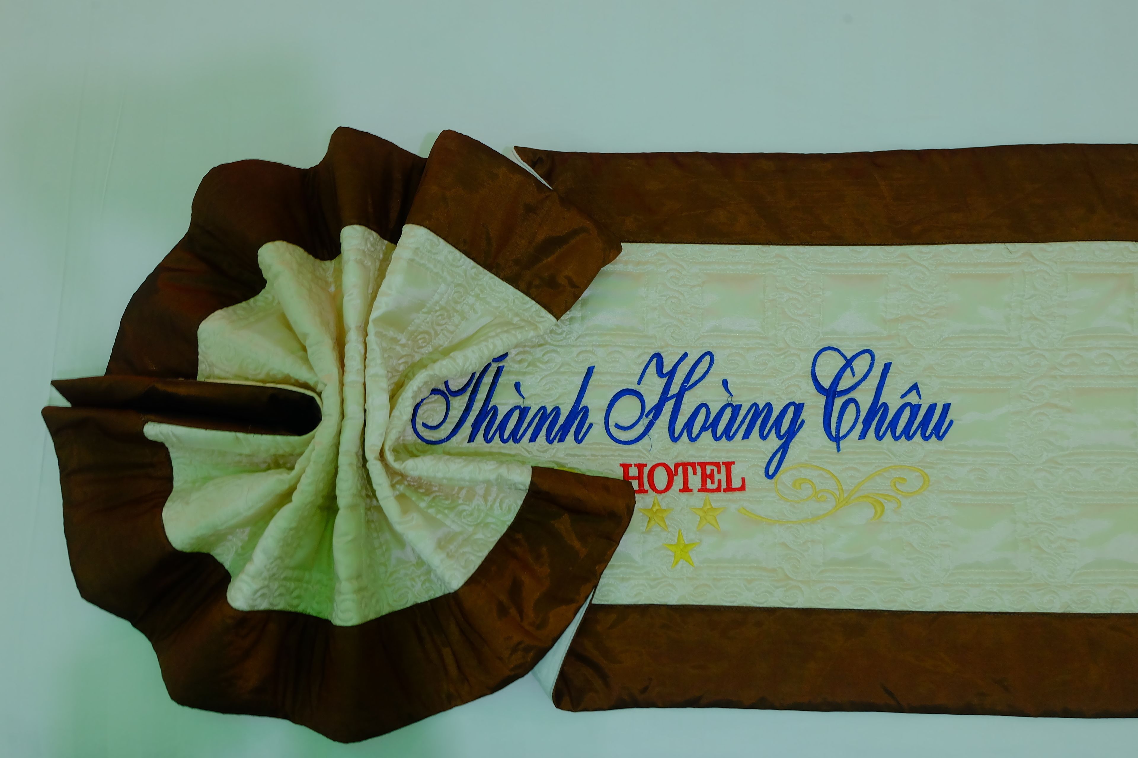 A decorative banner with the text "Thanh Hoang Chau HOTEL" and a floral design.