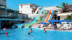 A swimming pool with multiple water slides and lounge chairs. - Side Yesiloz Hotel - All inclusive (Manavgat)