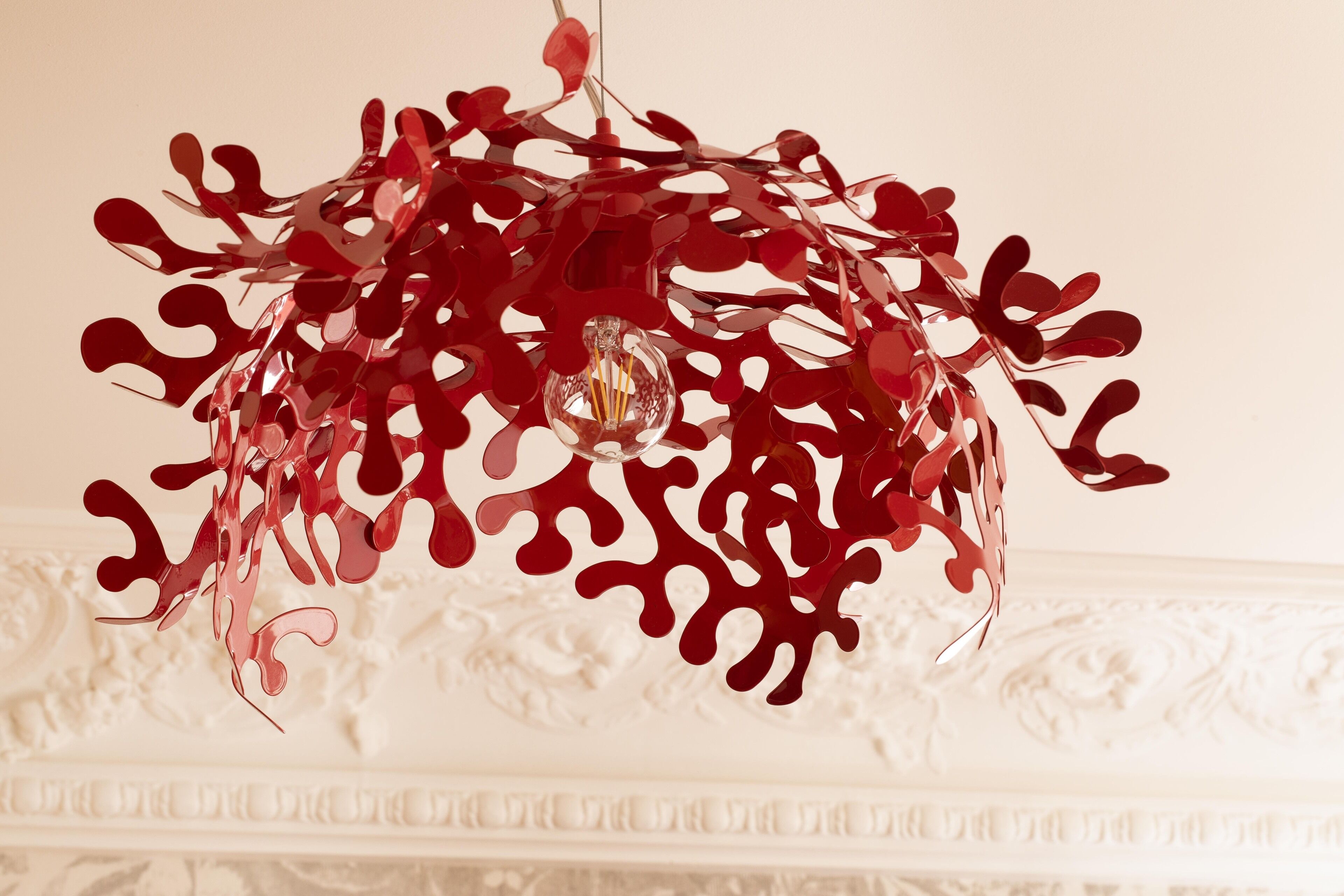 A chandelier with a unique red glass design.