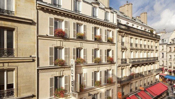 A multi-story hotel with classic European architecture, featuring balconies with flower boxes and a prominent 'HOTEL' sign. - Hôtel du Levant (Paris)