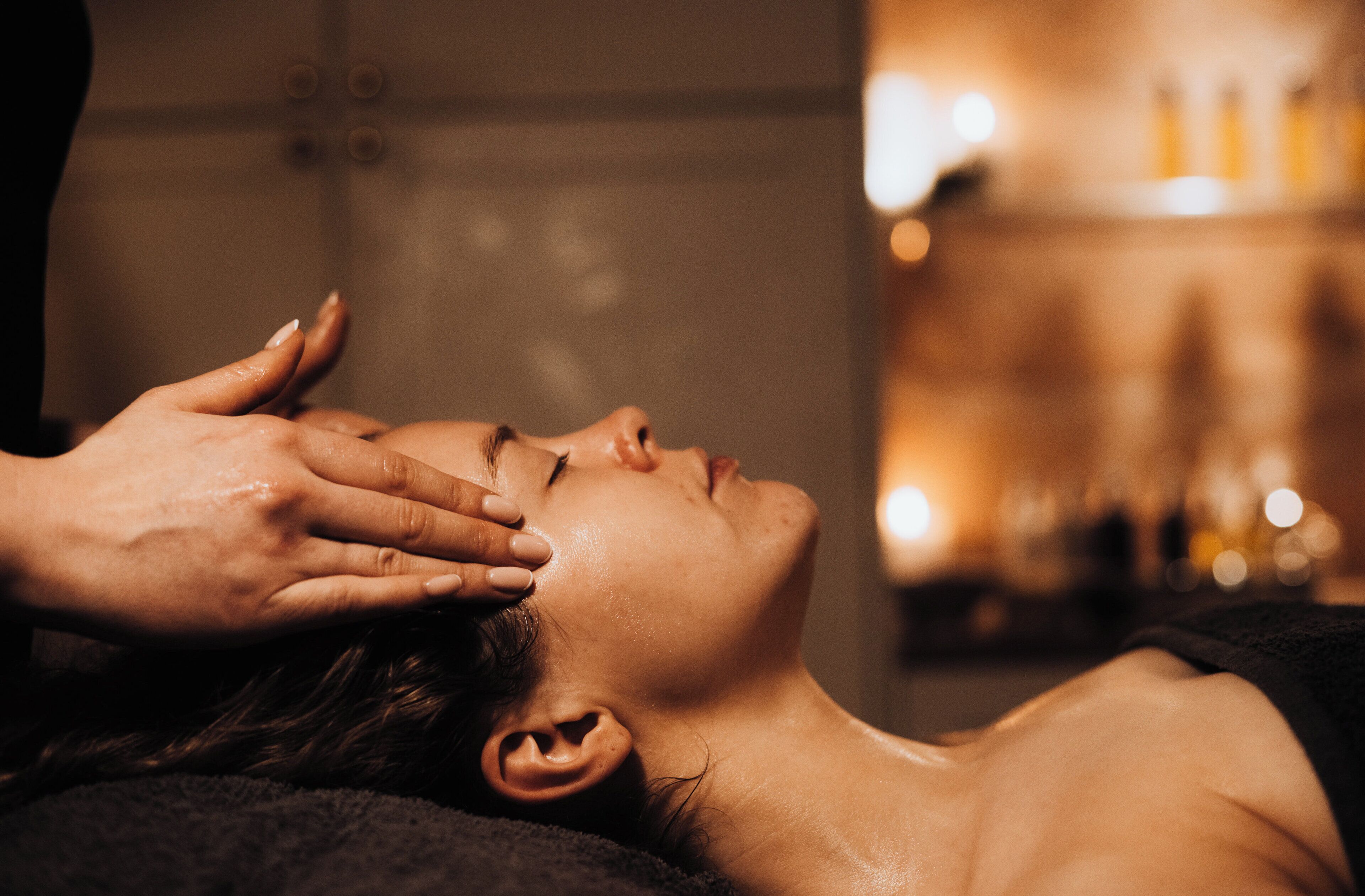 A person receiving a head massage.