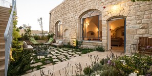A stone building with a courtyard, outdoor seating, and a sign reading "The Wong Room". - The Way Inn (Safed)